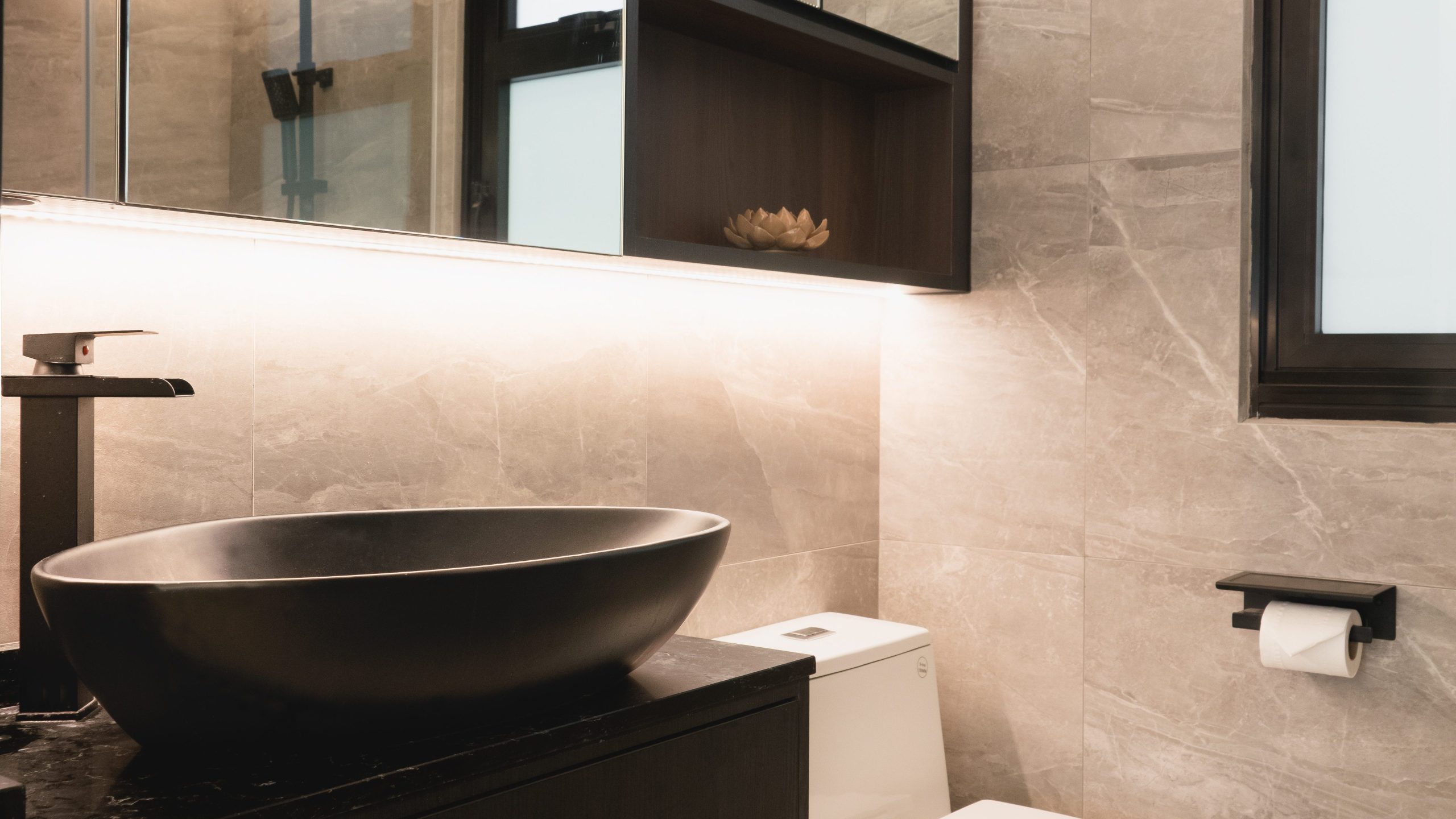 Bathroom with countertop sink and under cabinet lighting